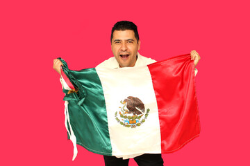 40-year-old dark-skinned mexican man proudly shows the flag of Mexico in celebration of Independence Day and Cinco de Mayo