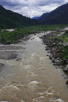 mountain river balason, flowing through the lush green valley of terai region on himalayan foothills area near dudhia, darjeeling district in india