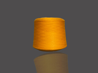 Yellow bobbin of thread