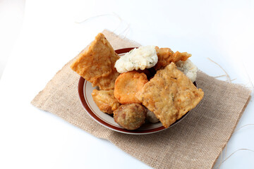 Indonesian fried foods. traditional street food made from flour, vegetables, tofu, tempeh etc and served with green chili. with copy space. fried food, isolated