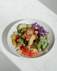 Vibrant salad with grilled cheese, avocado, and fresh vegetables