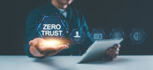 Embracing the zero trust security concept, a businessman holds a zero trust icon on a virtual screen, symbolizing enhanced business information security for the network.