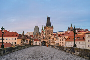 Fototapeta premium Prague's Lesser Town Bridge Tower Malostranska mostecka vez at the famous Charles Bridge at sunrise in the early morning with a beautiful sky, Prague, Czech Republic
