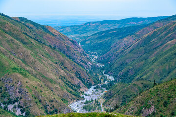 Issyk Gorge, Almaty, Kazakhstan. Top view of the river, mountain slopes and trees. Ecologically clean area Lake Issyk