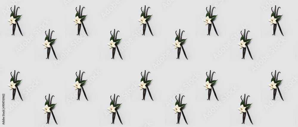 Wall mural aromatic vanilla sticks and flower on grey background