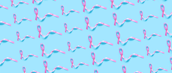 Pink awareness ribbon on blue background. World Cancer Day