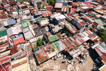 Aerial of densely packed and small shanty houses with shoddy construction at a squatter colony in Metro Manila.