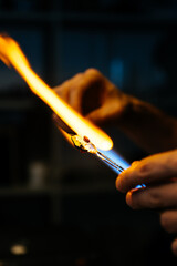 Close-up of a Skilled Glassblowing Artist Meticulously Heating a Crystal Fish