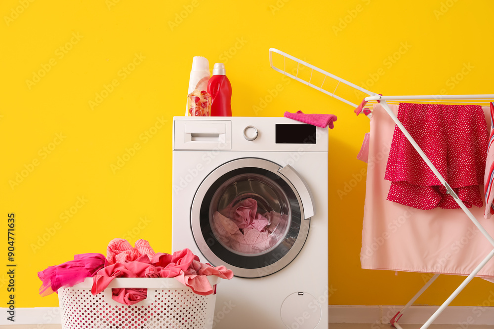 Wall mural Basket with dirty clothes, washing machine and dryer in laundry room