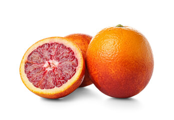 Tasty half and whole blood oranges on white background