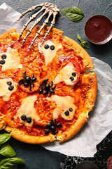 Tasty pizza for Halloween celebration on black background