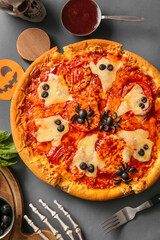 Tasty pizza for Halloween celebration on grey background