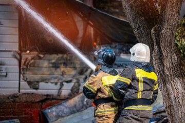 Fire incident in building. Action photo fireman team extinguishes burn with hose water