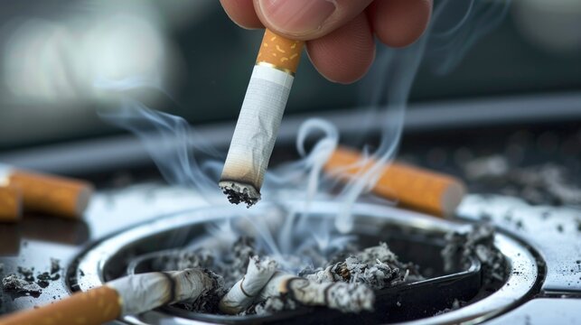 Hand putting out cigarette in car ashtray
