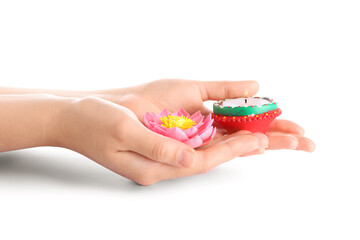 Female hands with candle and lotus flower for celebration of Divaly isolated on white background