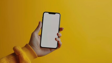 A person is holding a cell phone with a yellow background