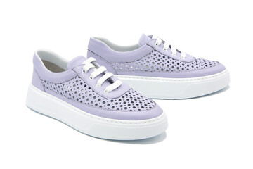 Sneakers. Pair of fashionable leather shoes with perforated inserts isolated on white background.