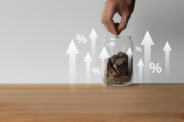 percentage increase of saving money. Coins in a glass jar, percentage symbol, arrow pointing up. The concept of growth in saving money