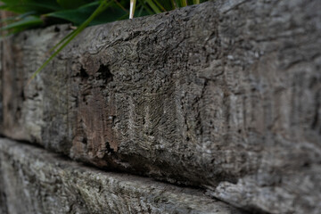 Close up texture of rustic weathered wooden railway sleeper used for garden bed