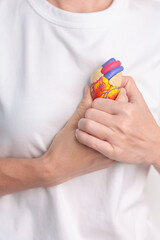 Woman holding human Heart model. Cardiovascular Diseases, Atherosclerosis, Hypertensive Heart,...