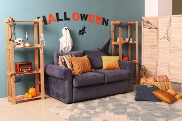 Interior of living room decorated for Halloween with sofa and shelf units