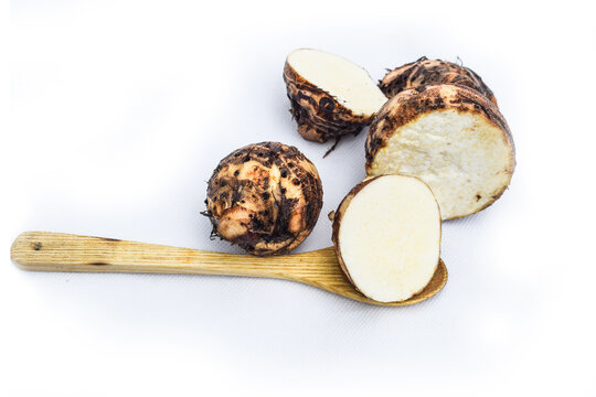 fresh Taro root or eddoes root isolated on white background, halves of taro root. Rotating on the turntable. Isolated on the white background. Close-up. Macro.