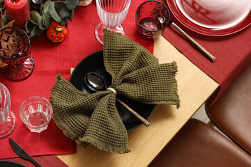 Halloween table setting with folded napkin and cutlery, closeup