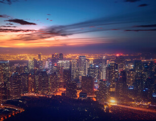 Beautiful aerial view of modern city skyline and skyscrapers at crimson sunset in the evening