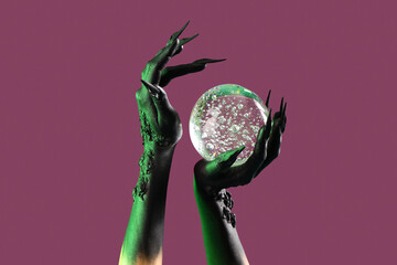 Hands of witch with crystal ball on purple background. Halloween celebration