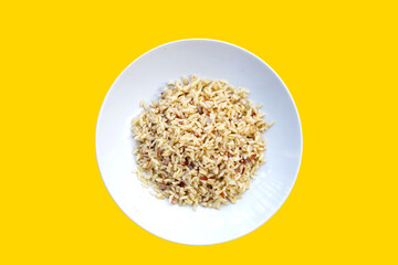 Cooked brown brown rice in white plate