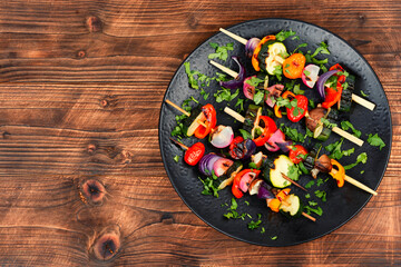 Grilled vegetables on skewers, space for text.