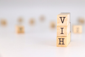 Human Immunodeficiency Virus in spanish language. VIH aconym written on wooden cubes isolated on white background with copy space for text