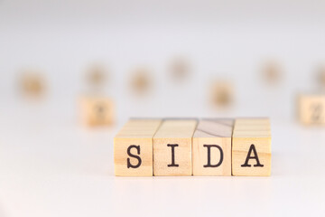Word SIDA written in Spanish language on wooden cubes isolated on white background with copy space for text. aids concept
