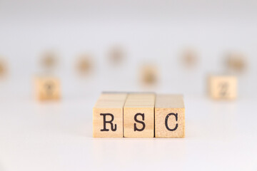 Corporate Social Responsibility acronym. RSC acronym on spanish language written on wooden cubes isolated on white background with copy space for text.