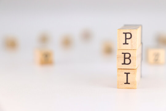 PBI letter - Gross Domestic Product in Spanish language written on wooden cubes isolated on white background with copy space for the text