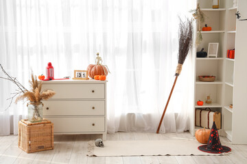 Interior of living room decorated for Halloween with commode and shelf unit