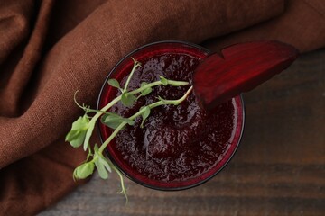 Tasty beetroot smoothie with microgreens in glass on wooden table, top view. Vegan drink