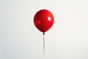 Joyful silhouette of a red balloon representing happiness in the sky