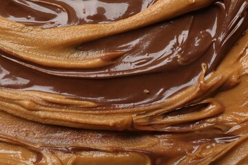 Tasty peanut butter as background, top view