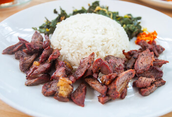 Se'i Sapi or Beef Sei is Indonesia Traditional Smoked Beef, Served with Rice, Soup, Boiled Cassava Leaves and Sambal Luat or Sambal Matah. Typically Food from East Nusa Tenggara, Indonesia.