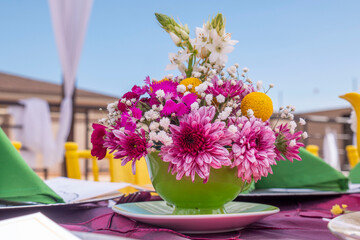  A captivating arrangement of pink and white chrysanthemums, baby's breath, and yellow accents in a...