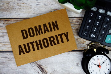 Domain Authority text with alarm clock and calculator on wooden background, Business concept