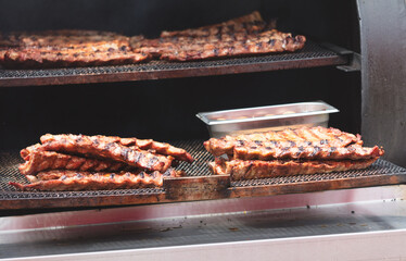 Barbecue meat is fried on a metal grate