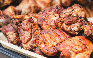 Barbecue meat is fried on a metal grate
