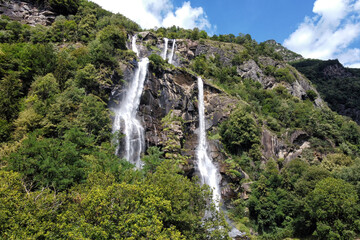 Waterfalls flowing down a mountainside in the Italian alps