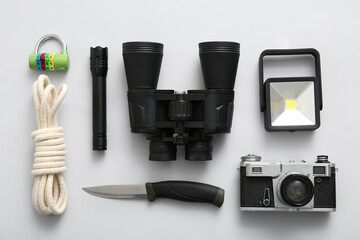 Composition with binoculars and travel items on white background