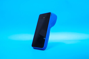 POS terminal with wireless card payments on blue background. Mockup of modern mobile smart payment terminal with NFC. 
