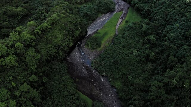 Teahupoo, Tahiti aerial drone through the river in the valley of mountain Orohena Aorai Ronui. French Polynesia 2024 Paris Olympics surfing spot. Paradise in Pacific Ocean. Moana Disney's inspiration.