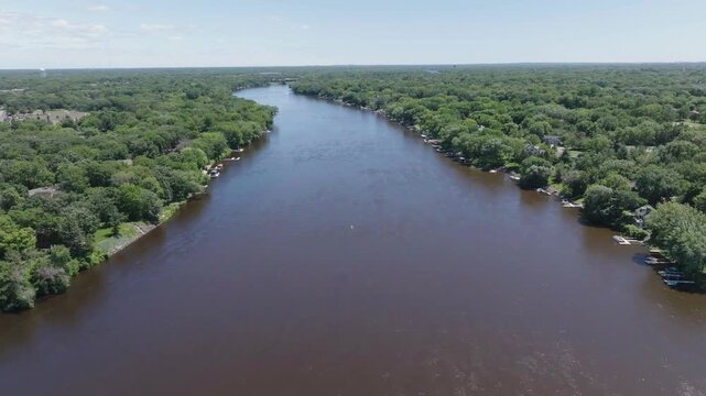 Wide angle shot capturing Mississippi river with dense forest on either ide in Minnesota, USA. Drone view.