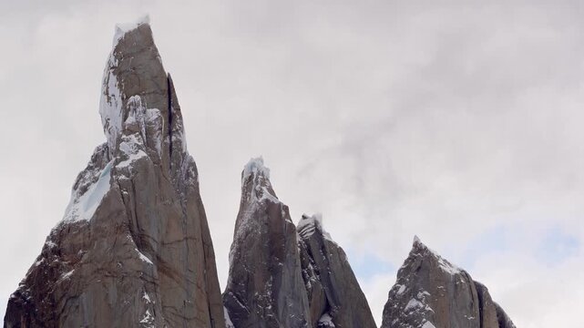 Up close establishing view of Cerro Torre summit in Patagonia, Argentina, El Chalten on a snowy winter cloudy day